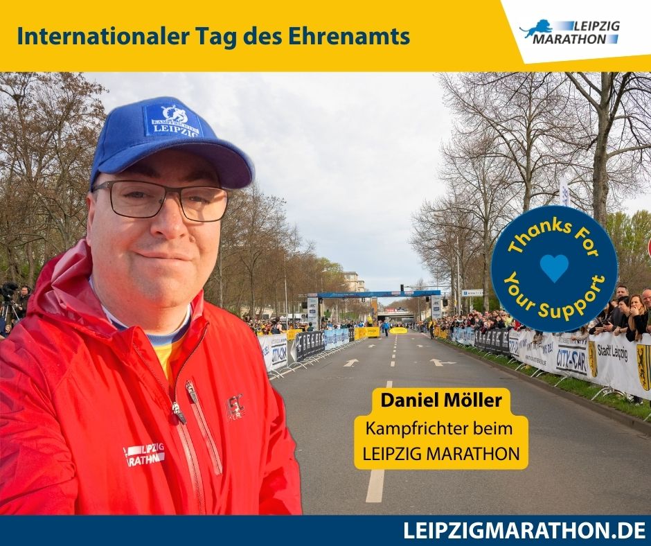 Person mit roter Jacke, gelbes Banner „Internationaler Tag des Ehrenamts
